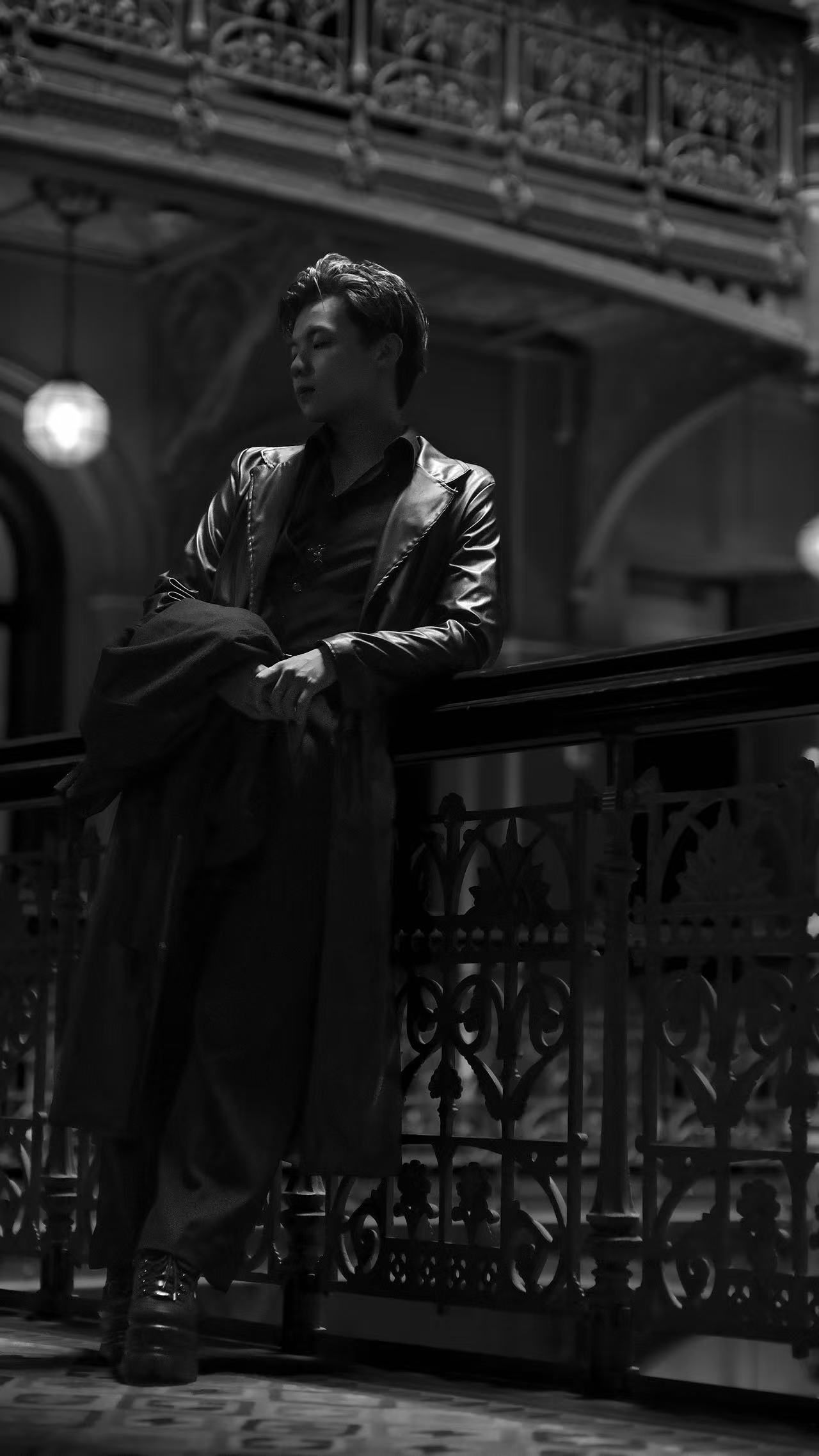 Universe Chen (Kuan Yu Chen), Principal Designer of CITTÀCICO, photographed in a dark coat against an ornate railing