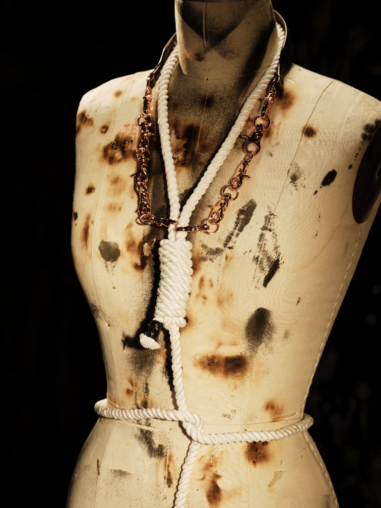 Banned — white rope and copper chain at the neck and waist